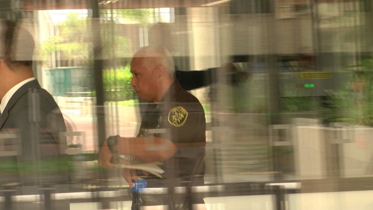 Cayetano, pictured behind the glass of the federal building in Honolulu on Wednesday. (Image:...