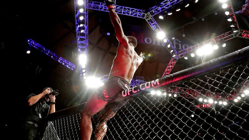 Karl Roberson celebrates his victory over Jack Marshman in a middleweight mixed martial arts...