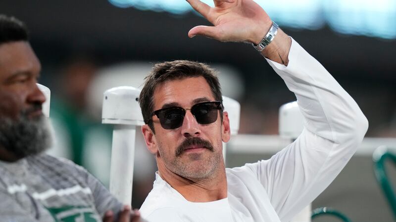New York Jets quarterback Aaron Rodgers waves to football fans before an NFL football game...