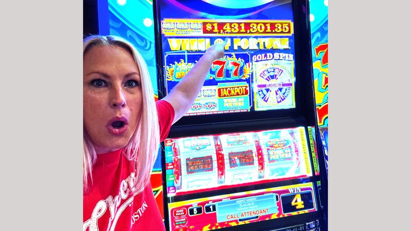 A player identified as Kathryn J. points to the winning $1.4 million IGT slot jackpot at the...