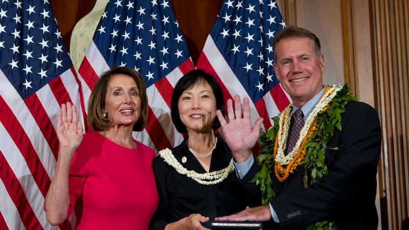 House Speaker Nancy Pelosi of Calif., administers the House oath of office to Rep. Ed Case,...