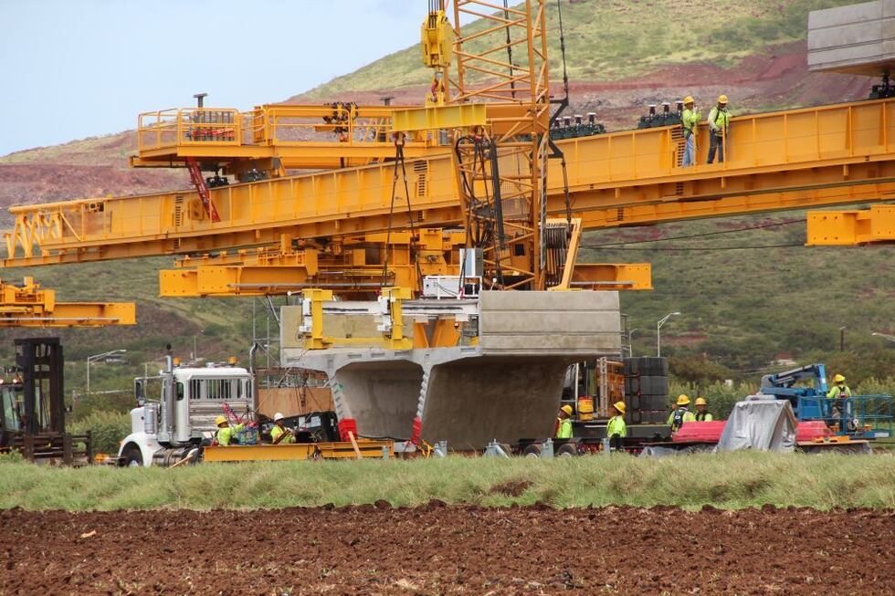 Crews working on the Honolulu rail project prepare to life a portion of the elevated guideway...