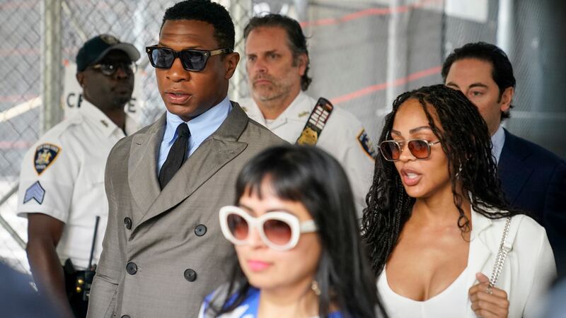 Jonathan Majors, left, and Meagan Good, right, leave court after a hearing on his domestic...
