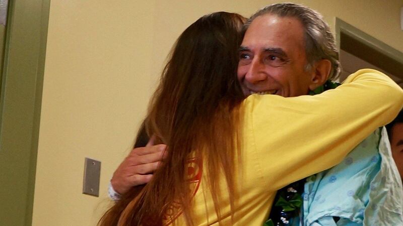 Larry Gambone hugs Elizabth Bradshaw, the lifeguard who noticed his struggle in the water....