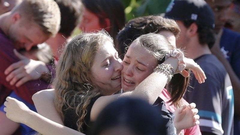 Students grieve at Pine Trails Park for the victims of the Wednesday shooting at Marjory...