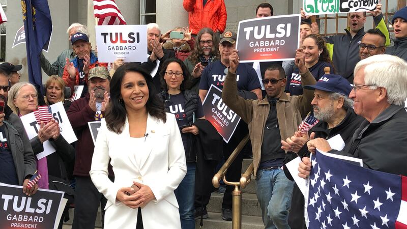 U.S. Rep. Tulsi Gabbard, of Hawaii, center, addresses a crowd outside the New Hampshire...