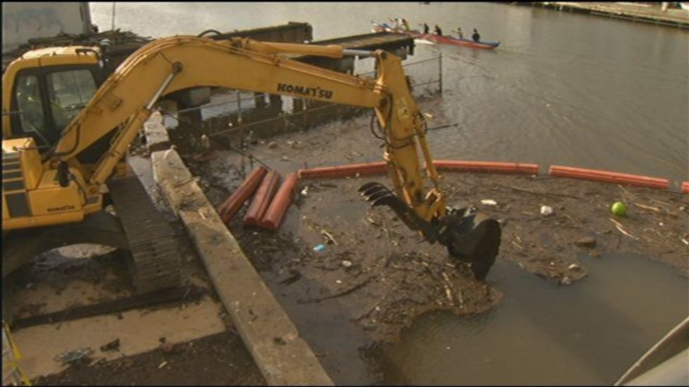 A contractor was cleaning the debris trap out with a backhoe.