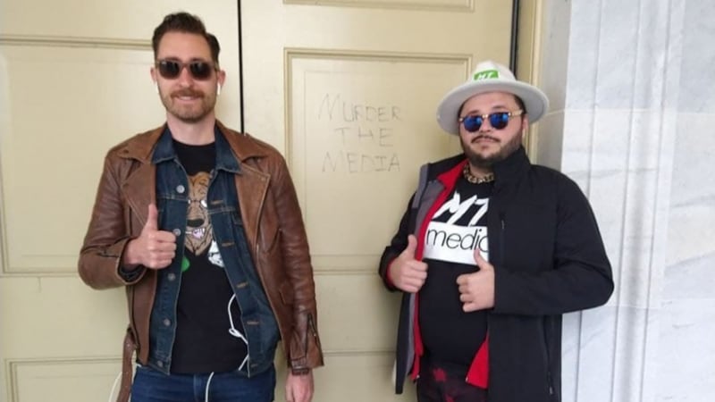 Nick Ochs (left) is shown in this photo after allegedly taking part in the US Capitol attack.