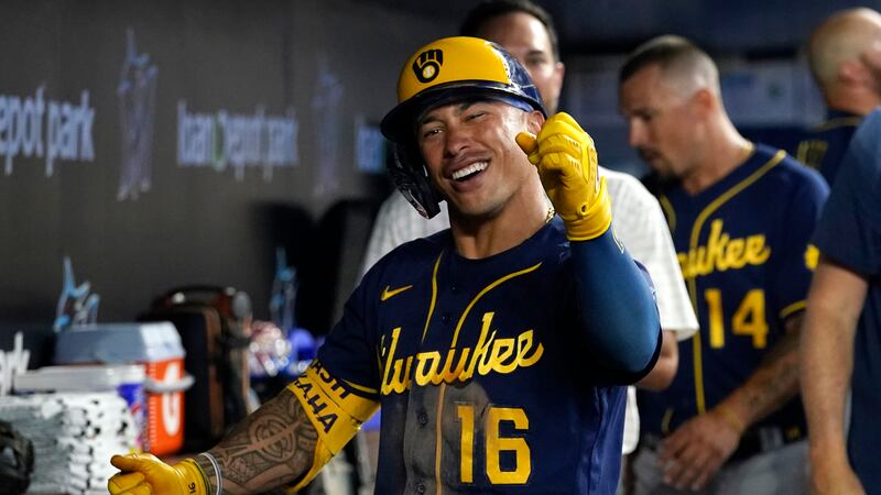 Milwaukee Brewers' Kolten Wong (16) reacts after hitting a solo home run during the fifth...