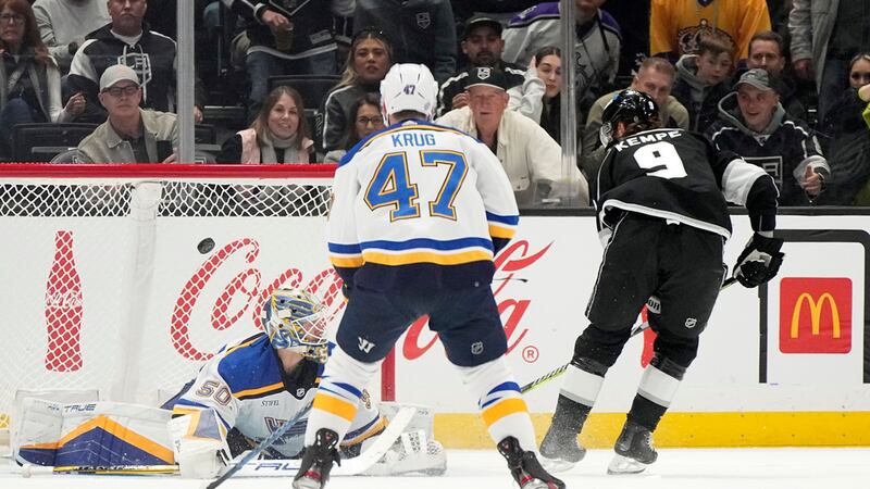 Los Angeles Kings center Adrian Kempe, right, scores on St. Louis Blues goaltender Jordan...