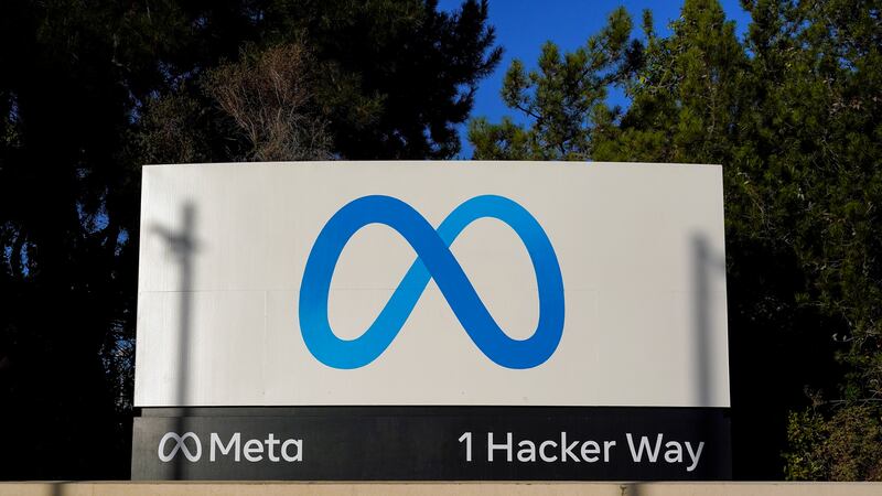 FILE - Meta's logo can be seen on a sign at the company's headquarters in Menlo Park, Calif.,...