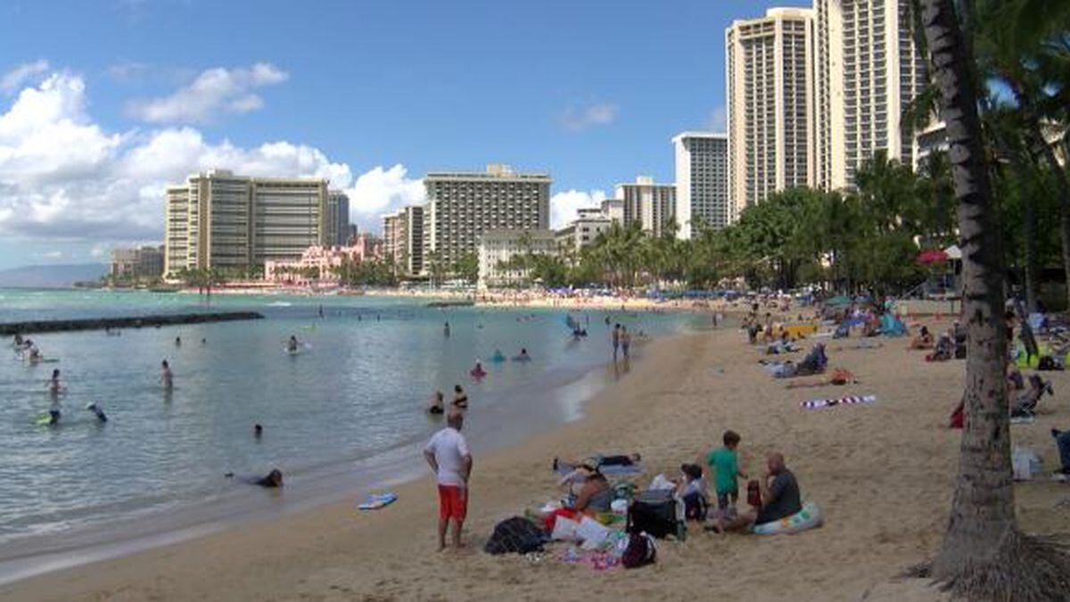 Visitors lounge on Waikiki on a Tuesday afternoon.